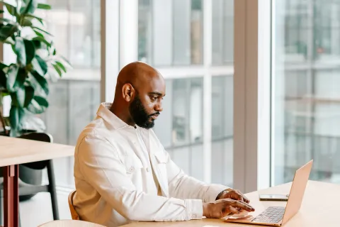 A man works on a laptop