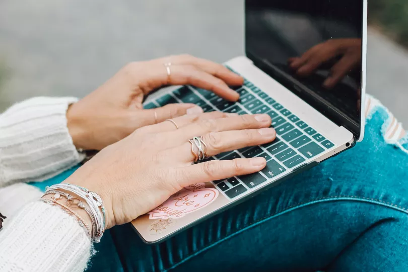 A person types on a computer